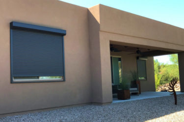 Rolling shutters on side window of a Tucson, Arizona home