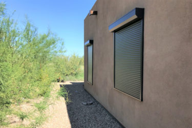 Rolling shutters on side window of a Tucson, Arizona home