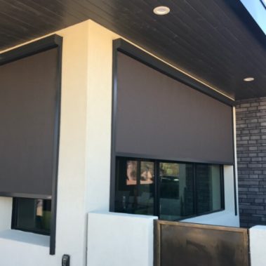 Retractable solar screens shading the windows of a Tucson, Arizona home