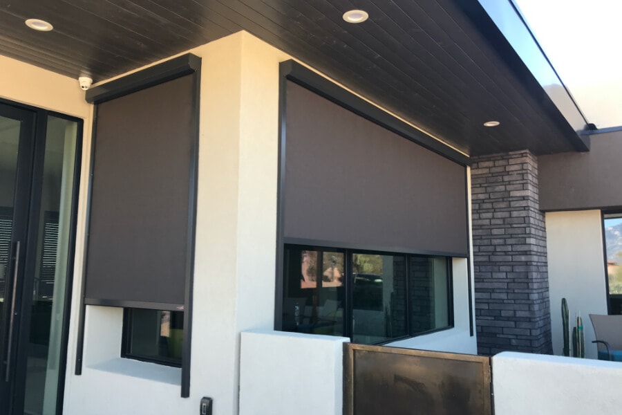 Retractable solar screens shading the windows of a Tucson, Arizona home