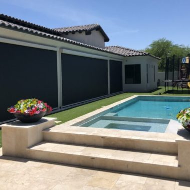 Home in Tucson, Arizona with retractable solar screens shading the patio