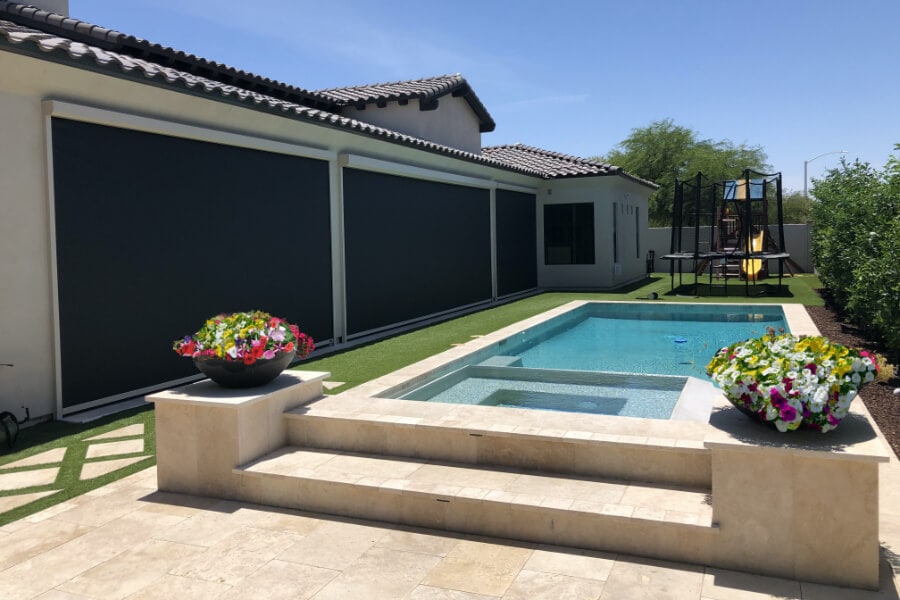 Home in Tucson, Arizona with retractable solar screens shading the patio