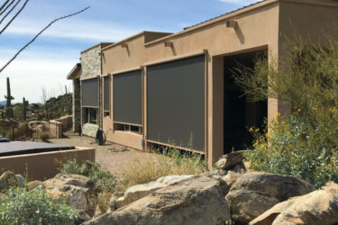 Home in Tucson, Arizona with retractable solar screens shading the patio