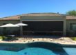 Home in Tucson, Arizona with retractable solar screens blocking the patio