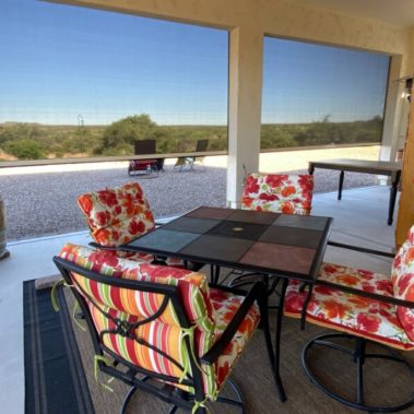 Retractable solar screens shading the patio of a Tucson, Arizona home