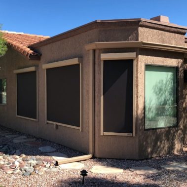 Exterior solar shades blocking windows of a Tucson, Arizona home