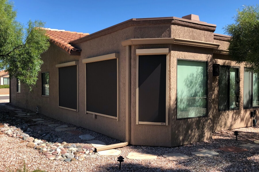 Exterior solar shades blocking windows of a Tucson, Arizona home