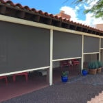 Solar screens half rolled down protecting patio furniture of a Tucson, Arizona home