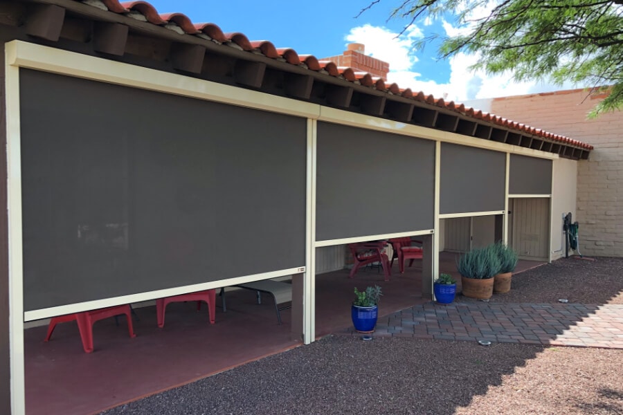 Solar screens half rolled down protecting patio furniture of a Tucson, Arizona home