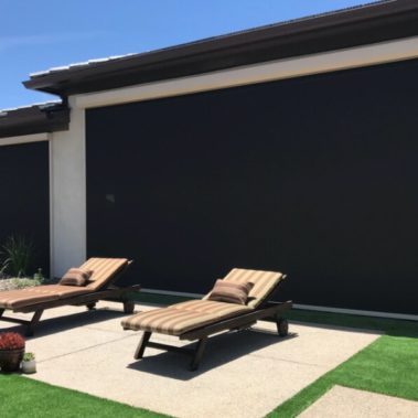 Retractable solar screens shading the patio of a Tucson, Arizona home