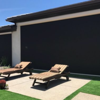 Retractable solar screens shading the patio of a Tucson, Arizona home