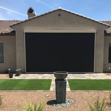Retractable solar screens shading the patio of a Tucson, Arizona home