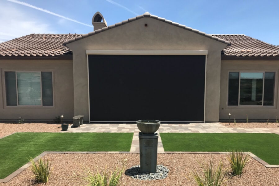 Retractable solar screens shading the patio of a Tucson, Arizona home
