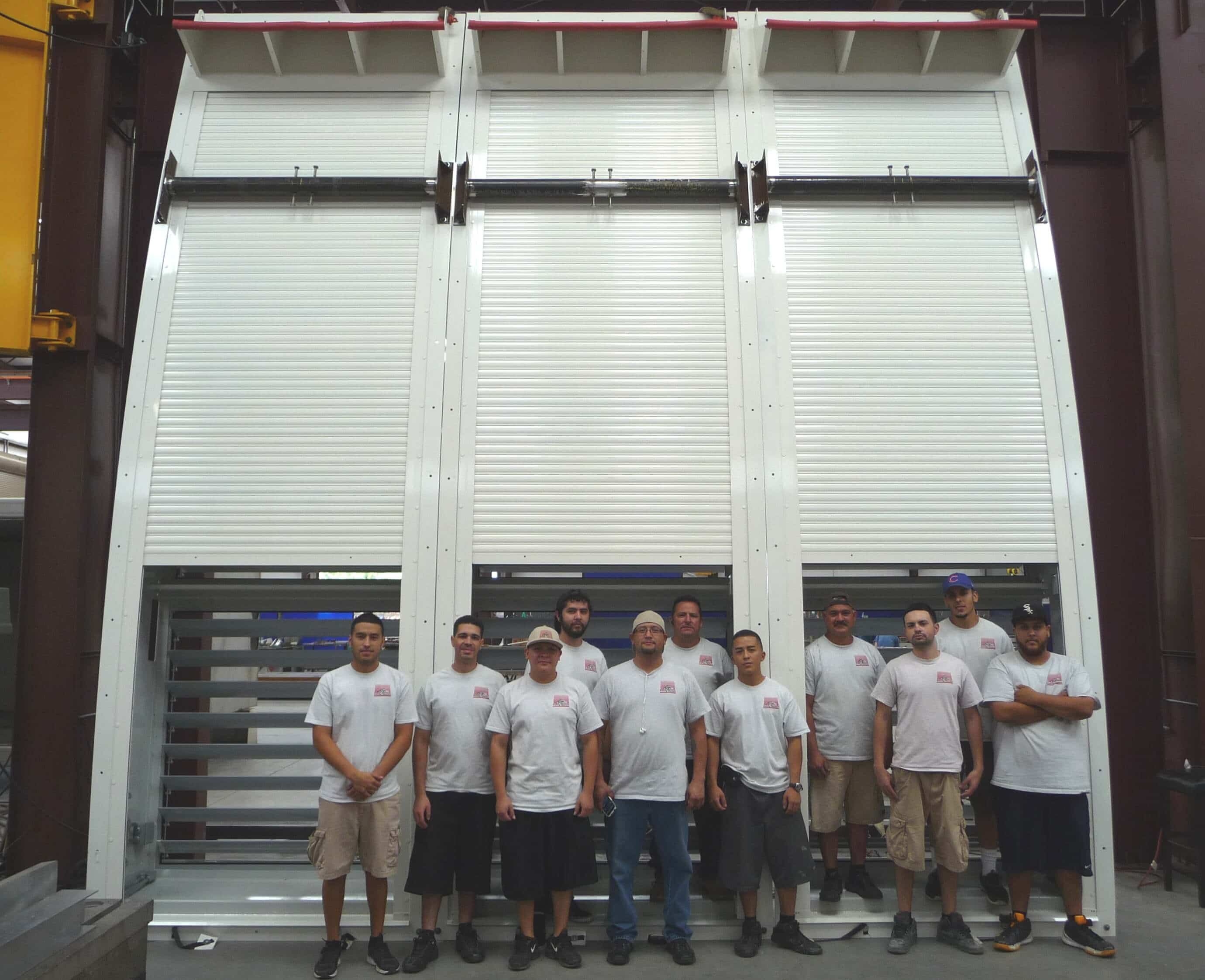 staff standing outside giant shutter