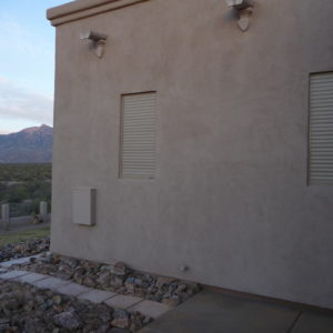 Exterior rolling shutters protecting windows of a home