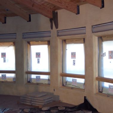 Rolling shades being installed during new construction
