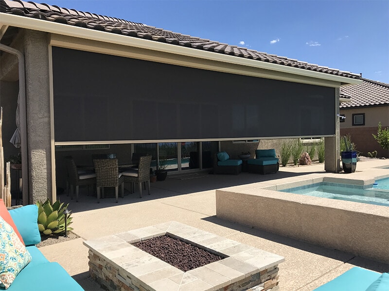 Pool side patio being shaded by rolling shades in Tucson, Arizona