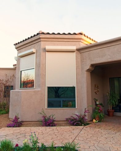 Cream colored rolling shutters windows of a home