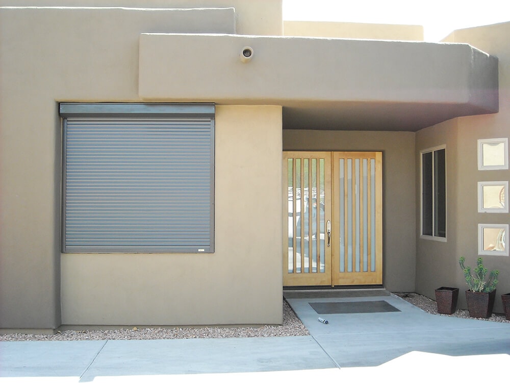 Rolling shutters protecting windows of a Tucson, Arizona home