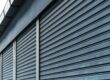 Closeup of a black, exterior commercial rolling shutter.