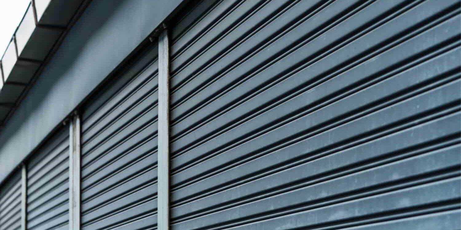 Closeup of a black, exterior commercial rolling shutter.