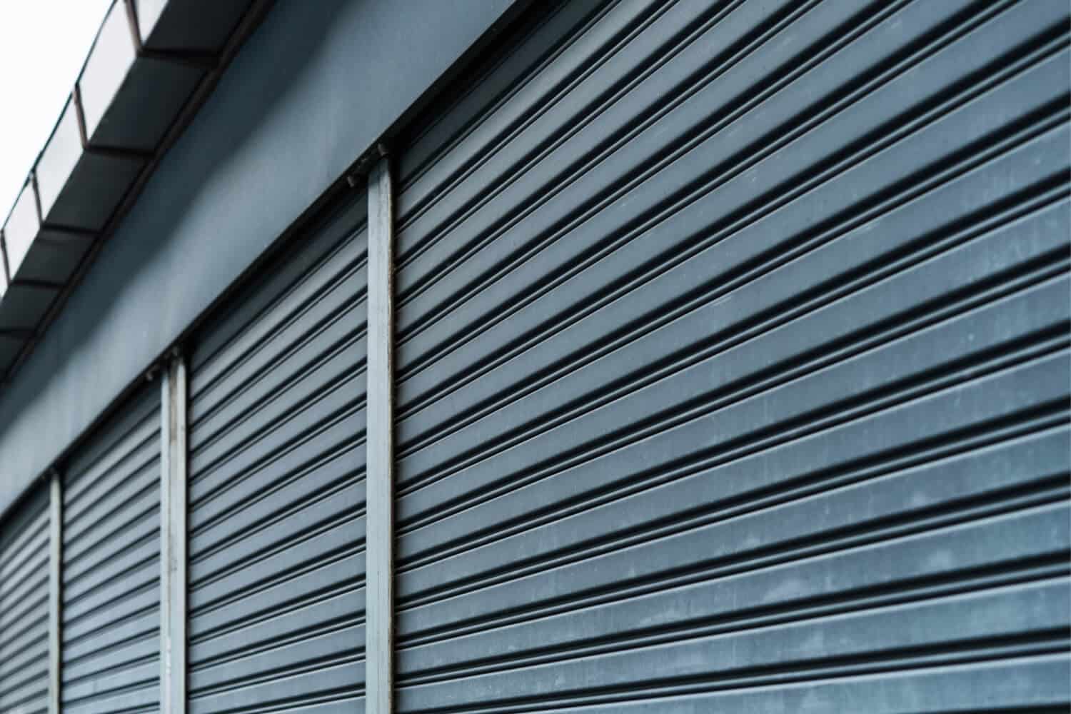 Closeup of a black, exterior commercial rolling shutter.